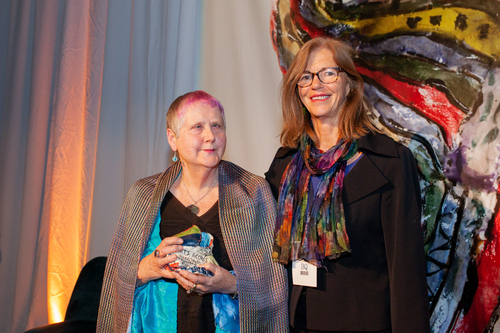 Robyn Hunt, recipient of the Arts Access Accolade 2019, with then Arts Access Aotearoa board Chair Dr Karen Webster. Robyn is holding her ceramic trophy in her hands