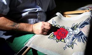 A prisoner working on embroidery