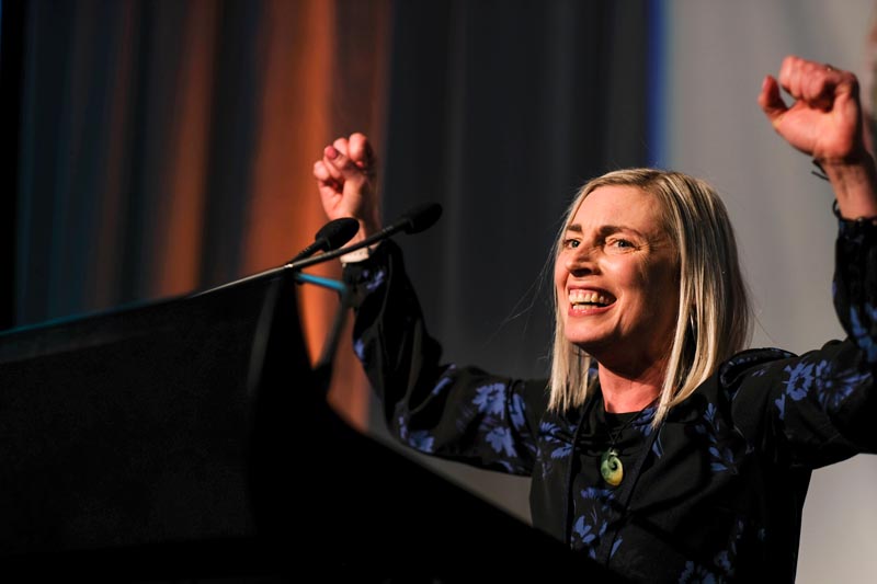 Ruth Ratcliffe raises her arms and smiles in celebration at the 2019 awards.