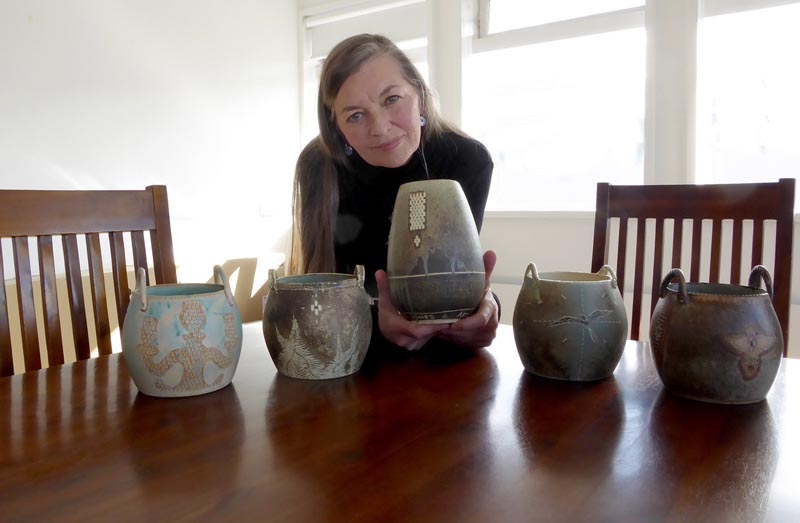 Ceramic artist Hedy Ankers with five award trophies.