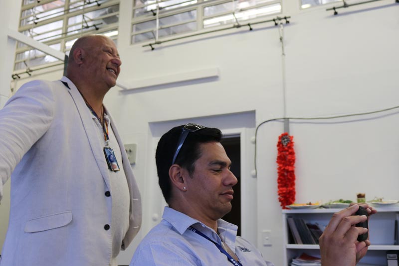 Hone Fletcher smiles as Lawrence Ereatara records using a cellphone during their work at Hawke's Bay Regional Prison.