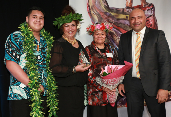 Mary Ama accepts an award on stage at the 2015 Arts Access Awards.