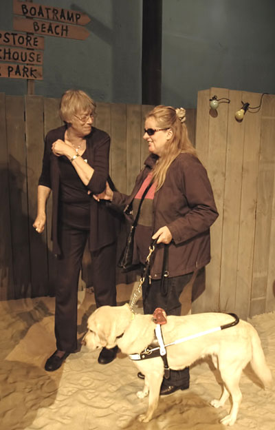 A blind patron enjoying a touch tour of the stage set at Fortune Theatre