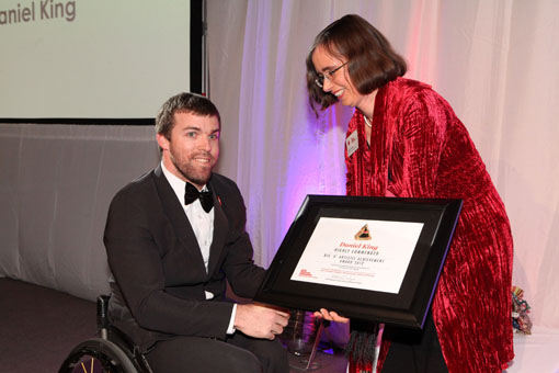 Daniel King receives his Big 'A' Award from Mojo Mathers