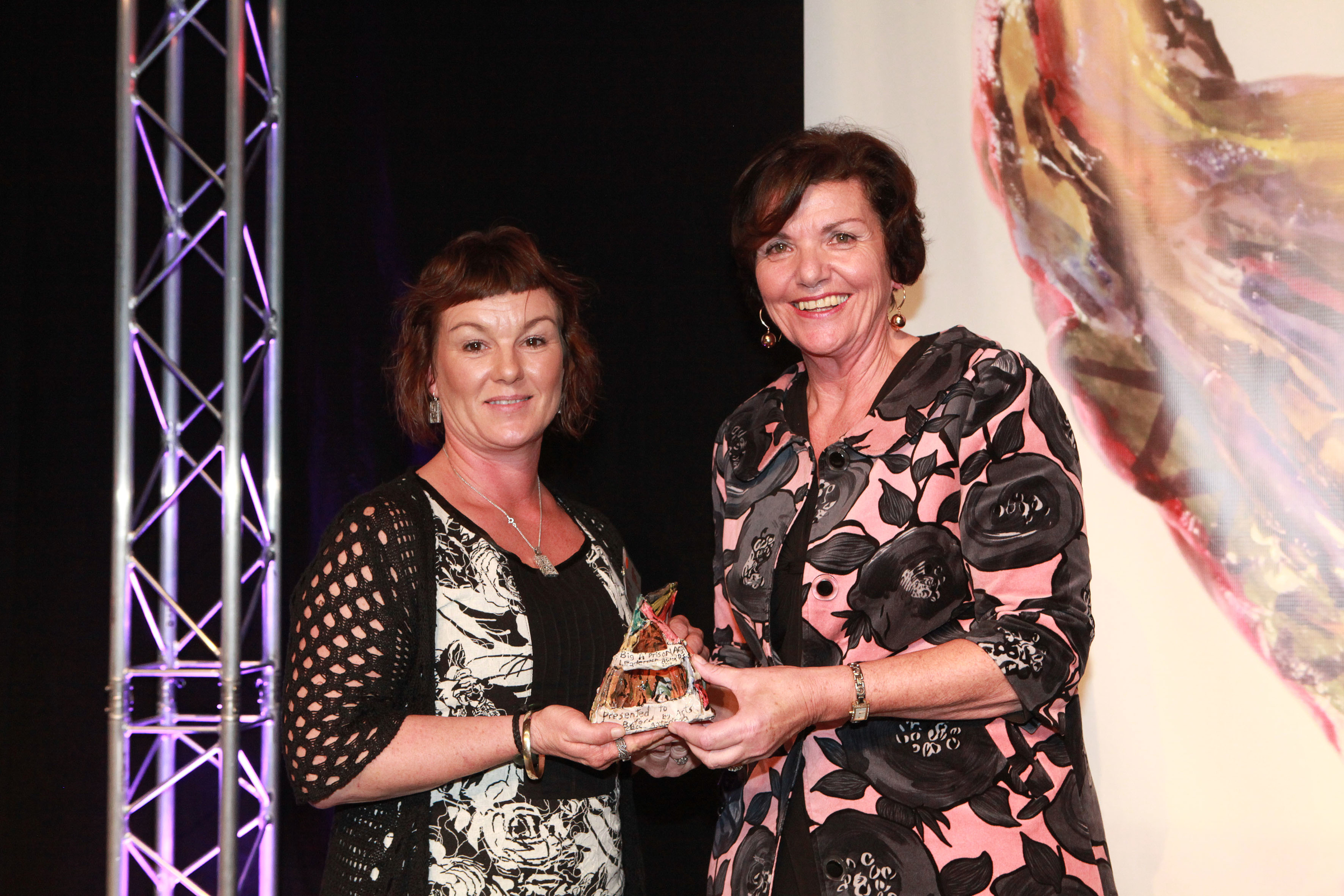 Minister for Corrections Hon. Anne Tolley (R) presents Big 'A' Prison Art Award to Ann Byford Prison Arts Tutor Waikeria Prison (L)