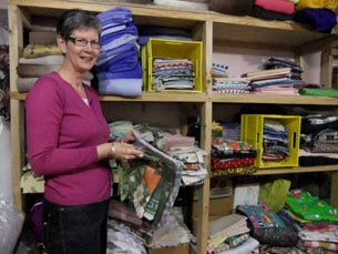 Jo, one of the volunteers  in the quilting storeroom