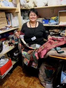 Trisha, a volunteer quilter in the storeroom