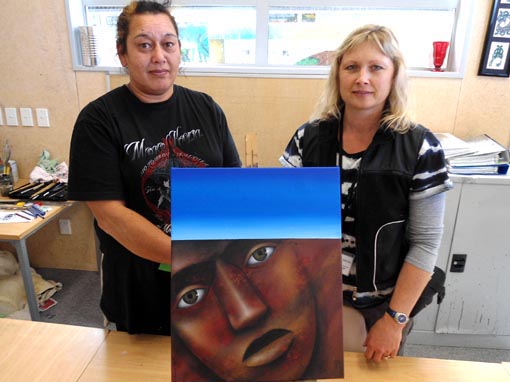 Theresa Reihana and Sandra Harvey with a painting donated by Theresa to sell and use the proceeds to buy art materials for the art classes